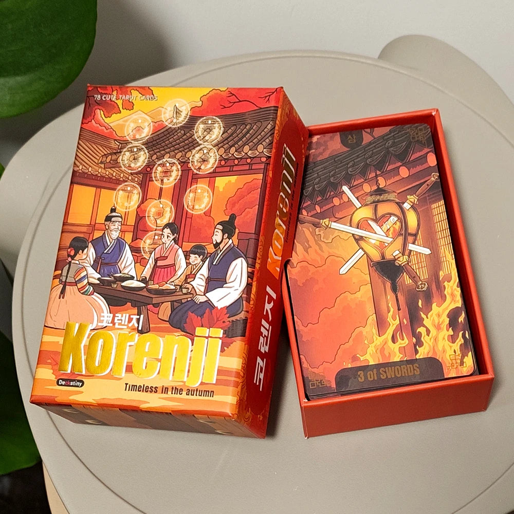 Korenji Tarot rigid box featuring a family in Korean Hanbok dining together in an autumn courtyard, with the 3 of Swords card visible in open box