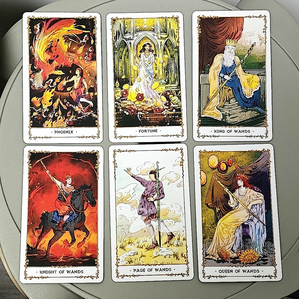 Silent Desolate Tarot — six face-up Wands court cards: Phoenix (woman with phoenix in flames), Fortune (woman with gold coins in cathedral), King of Wands (bearded king on throne), Knight of Wands (rider on black horse through fire), Page of Wands (figure with two wands in clouds), Queen of Wands (crowned woman with sunflowers)