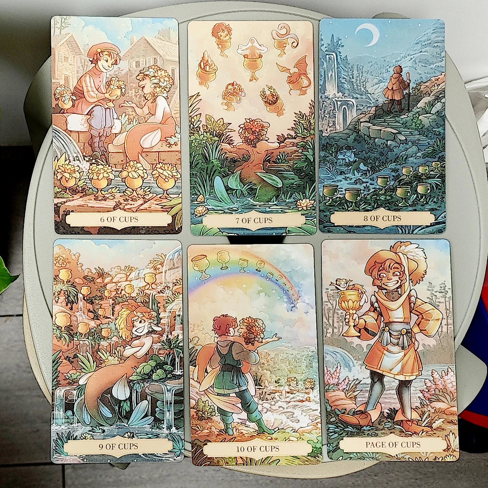 Once Upon a Time Tarot — six Cups suit cards: 6 of Cups (children with a water dragon in a flower garden), 7 of Cups (enchanted goblin creatures amid lily pads), 8 of Cups (lone figure walking away by moonlight ruins), 9 of Cups (fairy beside a waterfall garden), 10 of Cups (fairy child reaching toward a rainbow), Page of Cups (jaunty figure with a golden chalice by a waterfall)