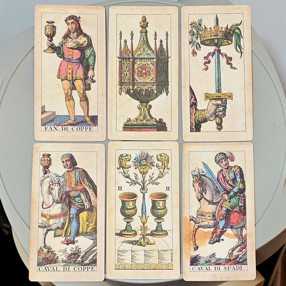 Tarocco Soprafino 1830 — six Minor Arcana face-up: Fan. di Coppe (pink-clad Renaissance page with jewelled chalice), Ace of Cups (tall Gothic chalice with red gemstone on dark pedestal), Ace of Swords (hand holding crowned sword with green ribbon), Caval di Coppe (knight on white horse holding chalice), II di Coppe (two paired ornate urns on chequered floor with gilt foliage), Caval di Spadi (armoured knight on rearing horse with sword)