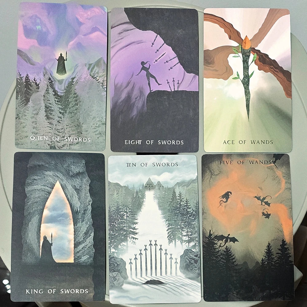 The Shadows We Cast Tarot — six cards: Queen of Swords, Eight of Swords, Ace of Wands, King of Swords, Ten of Swords, Five of Wands with dragons