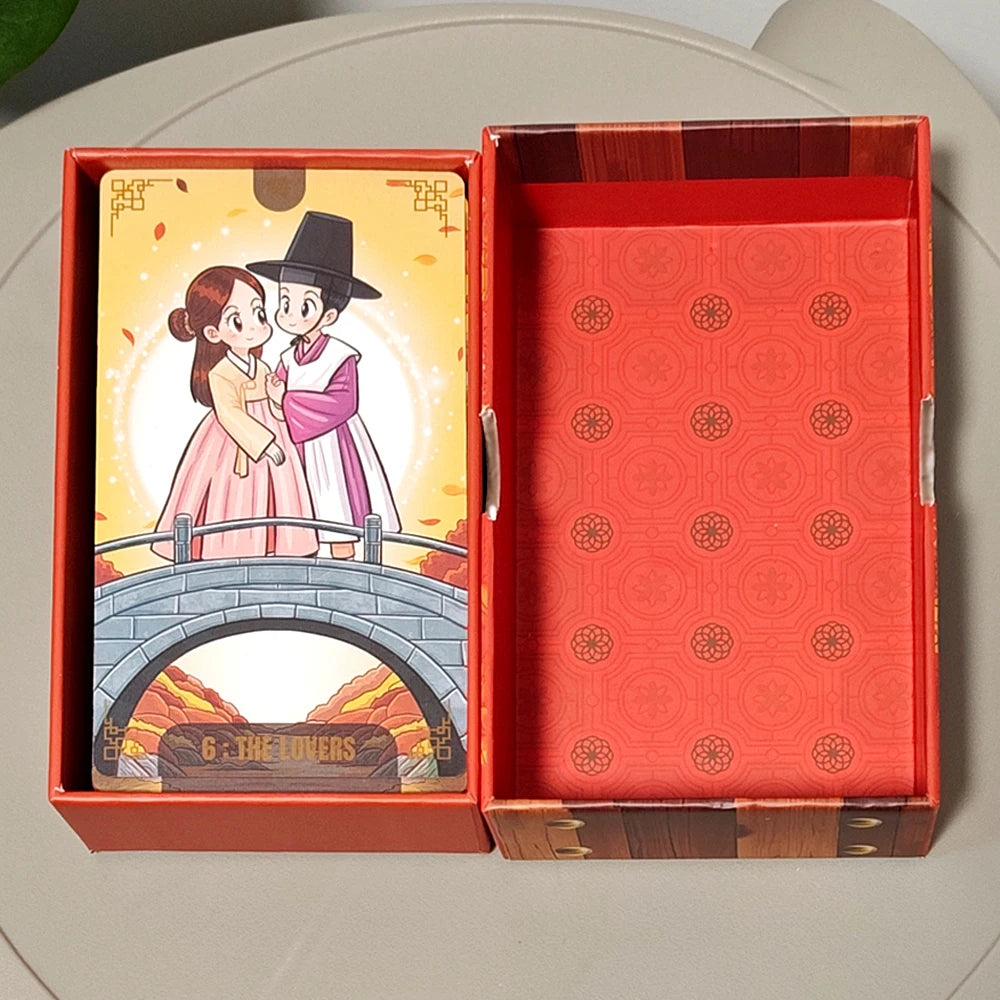 Korenji Tarot open rigid red box with The Lovers card (couple on bridge at dusk) and embossed red interior lining