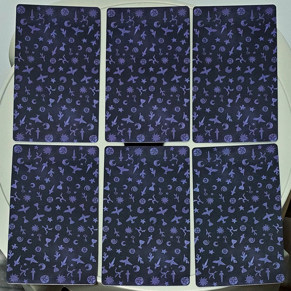 The Shadows We Cast Tarot — six card backs showing midnight blue pattern of ravens, pentacles, swords, moons, keys and esoteric symbols