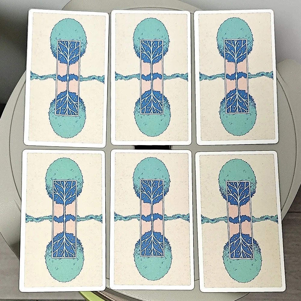 The Unveiled Tarot — six card backs showing teal Tree of Life design with mirrored canopy and root system on cream background
